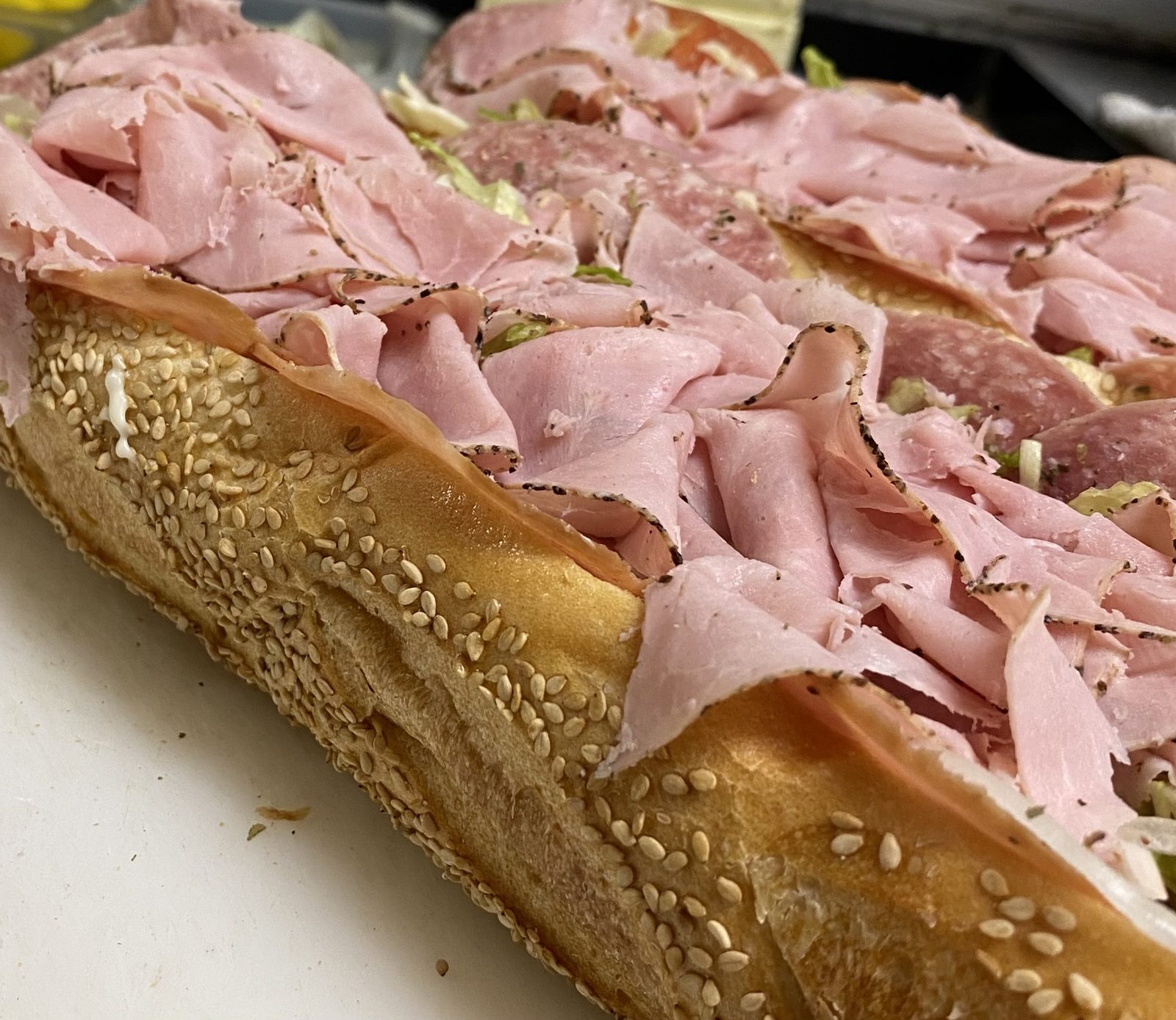 Italian hoagie with pepper ham, Genoa, capicola, and provolone on a seeded roll